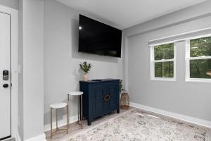 a living room with a blue cabinet and two stools at Gum Tree 01 with Wintergreen Advantage in Wintergreen