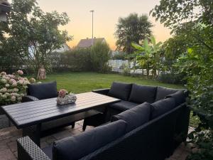 a patio with a table and a couch and a table at Casa Hortensia in Ettenheim