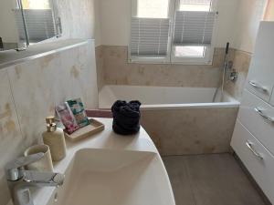 a bathroom with a tub and a sink and a bath tub at Casa Hortensia in Ettenheim