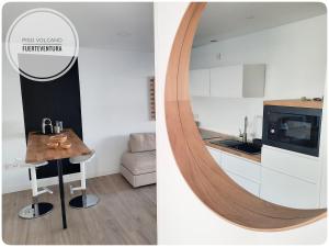 a kitchen with a mirror and a table in a room at Piso Volcano in Villaverde +8 photos