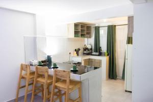 a kitchen with a table and chairs in a room at Kiriview Apartments in Nanyuki