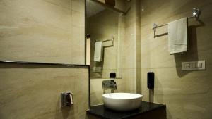 a bathroom with a sink and a shower at Hotel 36 Westinn Vikaspuri in New Delhi +25 photos