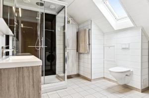 a bathroom with a toilet and a shower and a sink at Spacious 3-Bedroom Apartment with Balcony and Free Parking Orkland near Trondheim in Fannrem +9 photos
