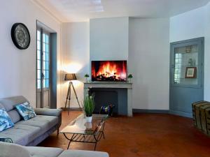 a living room with a couch and a fireplace at ROOM, Hostel in Carcassonne