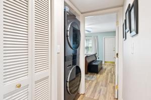 a washer and dryer in a room with a hallway at Chillin By The Creek - Condo in Downtown Gatlinburg! in Gatlinburg