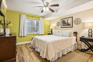 a bedroom with a bed and a ceiling fan at Chillin By The Creek - Condo in Downtown Gatlinburg! in Gatlinburg +13 photos