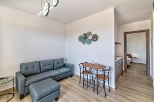 a living room with a couch and a table at A to Z in Palaiochora