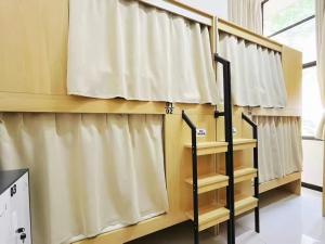 a row of curtains in a room at Natural Wake Youth Hostel in Hangzhou