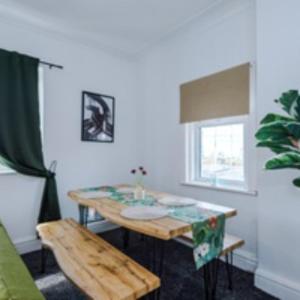 a living room with a table and a bench at 2 Bed Apartment ,Sea Views in Blackpool