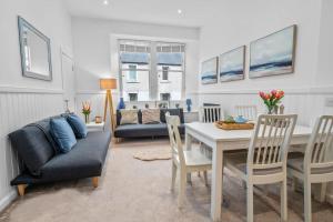 a living room with a table and a couch at Elegant 3BD Escape - Perfect Central Location in Oban