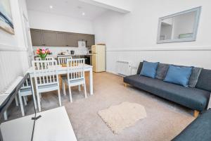 a living room with a couch and a table at Elegant 3BD Escape - Perfect Central Location in Oban