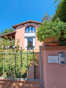 a house with potted plants on the front of it at Casa Madrigale in San Giovanni Valdarno