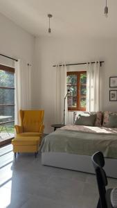 une chambre avec un lit et une chaise jaune dans l'établissement Home apartment Konopiště, 