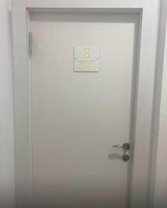 a white door with a sign on it at Romy boutique netanya in Netanya