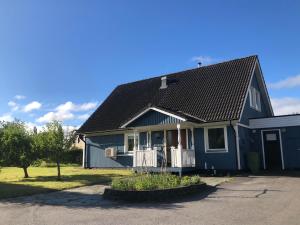 a blue house with a black roof at Villa Tina in Hammarstrand