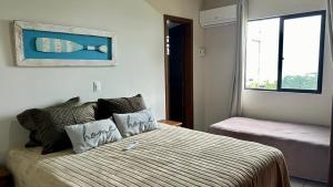 Una cama o camas en una habitación de Frente Mar Apartamento 3Q em Itapema, Meia Praia, suite e 2BWC, Ar Condicionado, Smart TV, garagem e churrasqueira na sacada