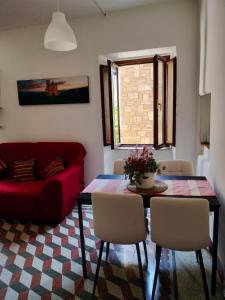 a living room with a red couch and a table at A casa mia in Santa Maria degli Angeli