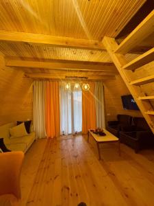 a living room with a couch and a table at Rakushki's house 2 in K'obulet'i