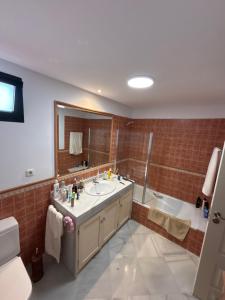 a bathroom with a sink and a bath tub at Las Colinas Beach in Manilva +3 photos