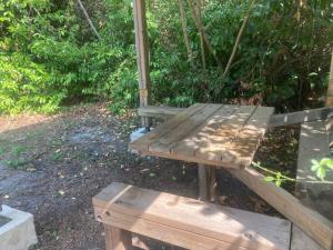 a wooden bench sitting on the ground in a park at campetoile in Montendre