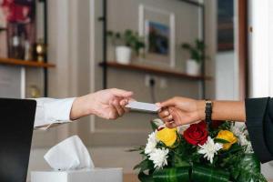 a person handing another person a remote control at Sunday Gateway Jeddah Formerly Beach Garden Hotel in Jeddah +39 photos