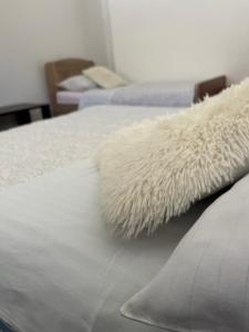 a white blanket on top of a bed at House Marijan in Korana