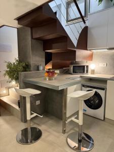 a kitchen with a counter with a bowl of fruit on it at Loft 19 Luxury Suite Boutique - Heated pool in Los Cristianos