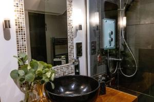 un bagno con un lavandino nero e una doccia di Historic Luxury 18th C Listed Barn Apartment a Maresfield Altre 38 foto