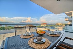 a table with a bowl of fruit on a balcony at Mateas Seaview Patio in Slatine