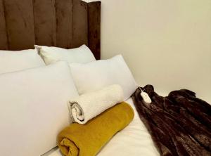 a bed with a towel and pillows on it at Randburg Urban Comfort Stay in Johannesburg +14 photos