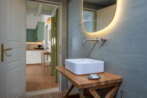 a bathroom with a white sink and a mirror at Villa Theoni in Halki +32 photos