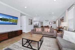 a living room with a couch and a table at Glorious Home Near Disney With Game Room, Themed Rooms, Waterpark & Resort Access At Encore Resorts Reunion - 7643Wi in Kissimmee