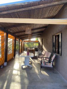 a patio with a table and chairs on it at Finca Las Corzuelas in Charbonier