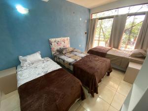 a bedroom with two beds and a window at Departamento en alquiler in Cambyretá +3 photos
