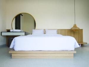 a bedroom with a large bed with a large mirror at Theolive Arrea - Spacious Private Pool and Backyard in Warung Menteng +15 photos