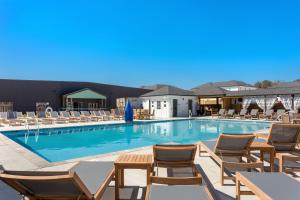 a swimming pool with lounge chairs and a hotel at BCW32A - Sea Escape in Corolla