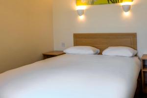 a bedroom with a bed with two pillows on it at Norbreck Castle Hotel Blackpool in Blackpool