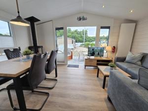 a living room with a couch and a table at Ostseeferienpark Walkyrien - Lotse i in Kagelbusch