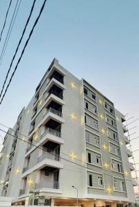 a tall apartment building with lights on it at Couple Canvas- Luxurious 1-BHK Peaceful Apartment in Siroli