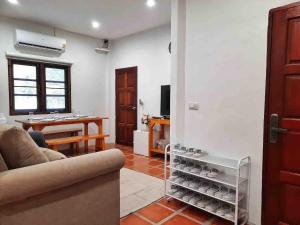 a living room with a couch and a table at Mi Casa Pool Villa Hua Hin in Hua Hin