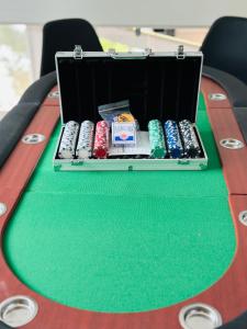 a table with a box of poker chips on it at La Marine - Maison Cesson Sévigné Spa & jeux in Cesson-Sévigné