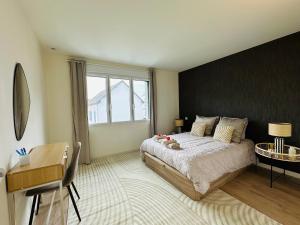 a bedroom with a large bed and a window at La Marine - Maison Cesson Sévigné Spa & jeux in Cesson-Sévigné