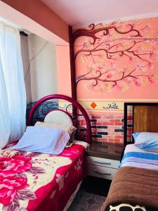 a bedroom with a bed with a painting on the wall at Backpacker hostal oruro in Oruro