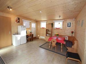 a kitchen and dining room with a table and a refrigerator at Chalet in Ötztal near Ötz-Hochötz Ski Resort in Umhausen