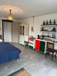 a room with a kitchen with a bed and a table at La Casa di Manu in Lessona +9 photos