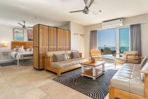 a living room with a couch and a bed at Camps Bay Village in Cape Town