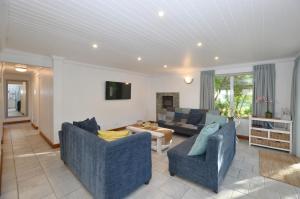 a living room with two chairs and a couch at Blue Crane in Yzerfontein