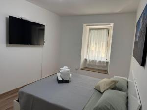 a bedroom with a bed and a flat screen tv at Casa IN 6 in Trento