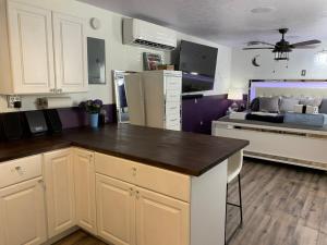 a kitchen with white cabinets and a black counter top at Rhinestone Cowboy in Hurricane