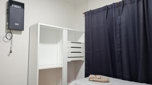 a bedroom with a bed and a black curtain at Temporario Rafaela in Rafaela